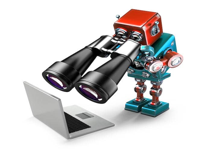 Robot holding binoculars and looking at laptop