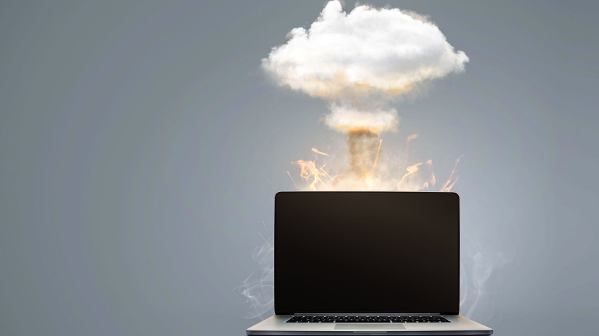 mushroom cloud above a laptop