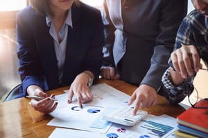 Image showing two professionals meeting over a document Image showing two professionals meeting over a document