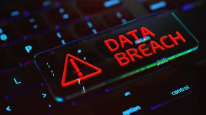 An alert of a data breach over a picture of a keyboard An alert of a data breach over a picture of a keyboard