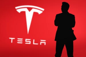 Elon Musk silhouette with Tesla logo in background.