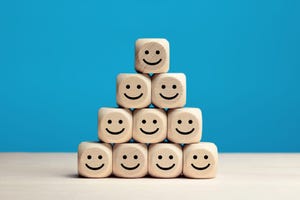 Smiling face icons on wooden cubes.