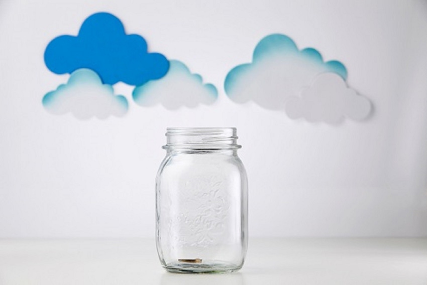 savings jar with clouds behind it