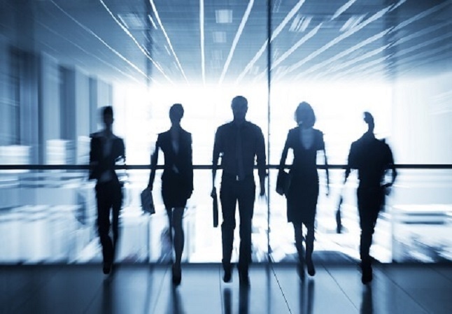 silhouettes of business people walking in hallway