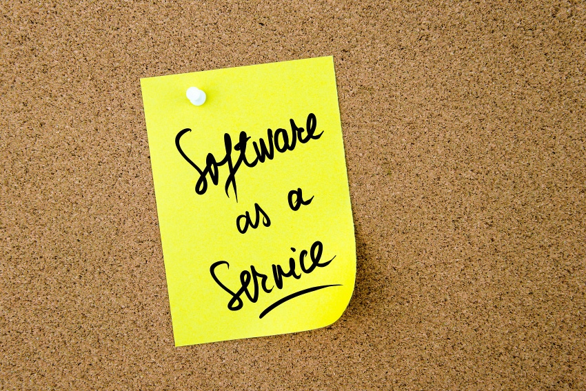 Software As A Service written on yellow paper note pinned on cork board with white thumbtack