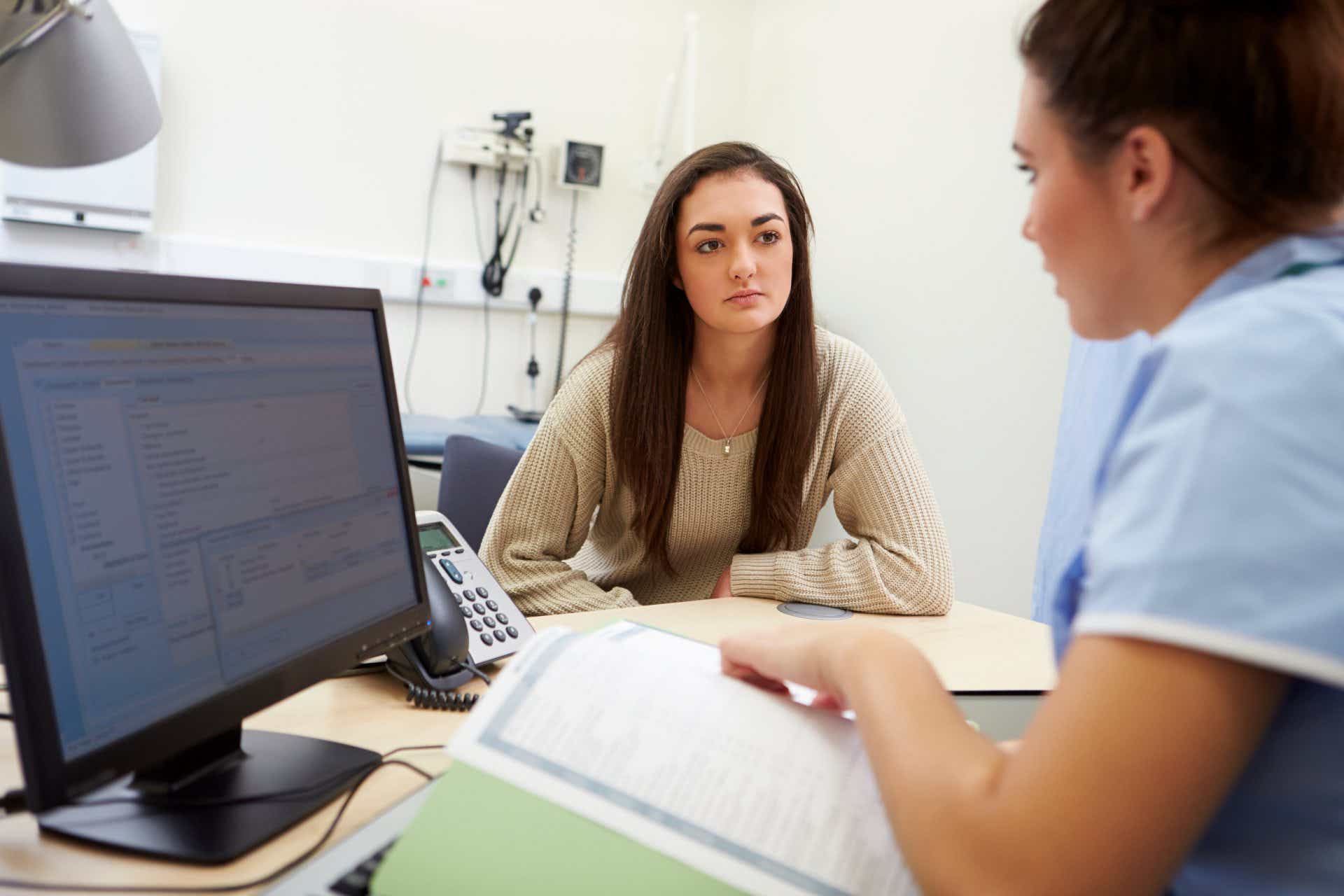 A patient consulting with an IBD nurse and discussing her medical records