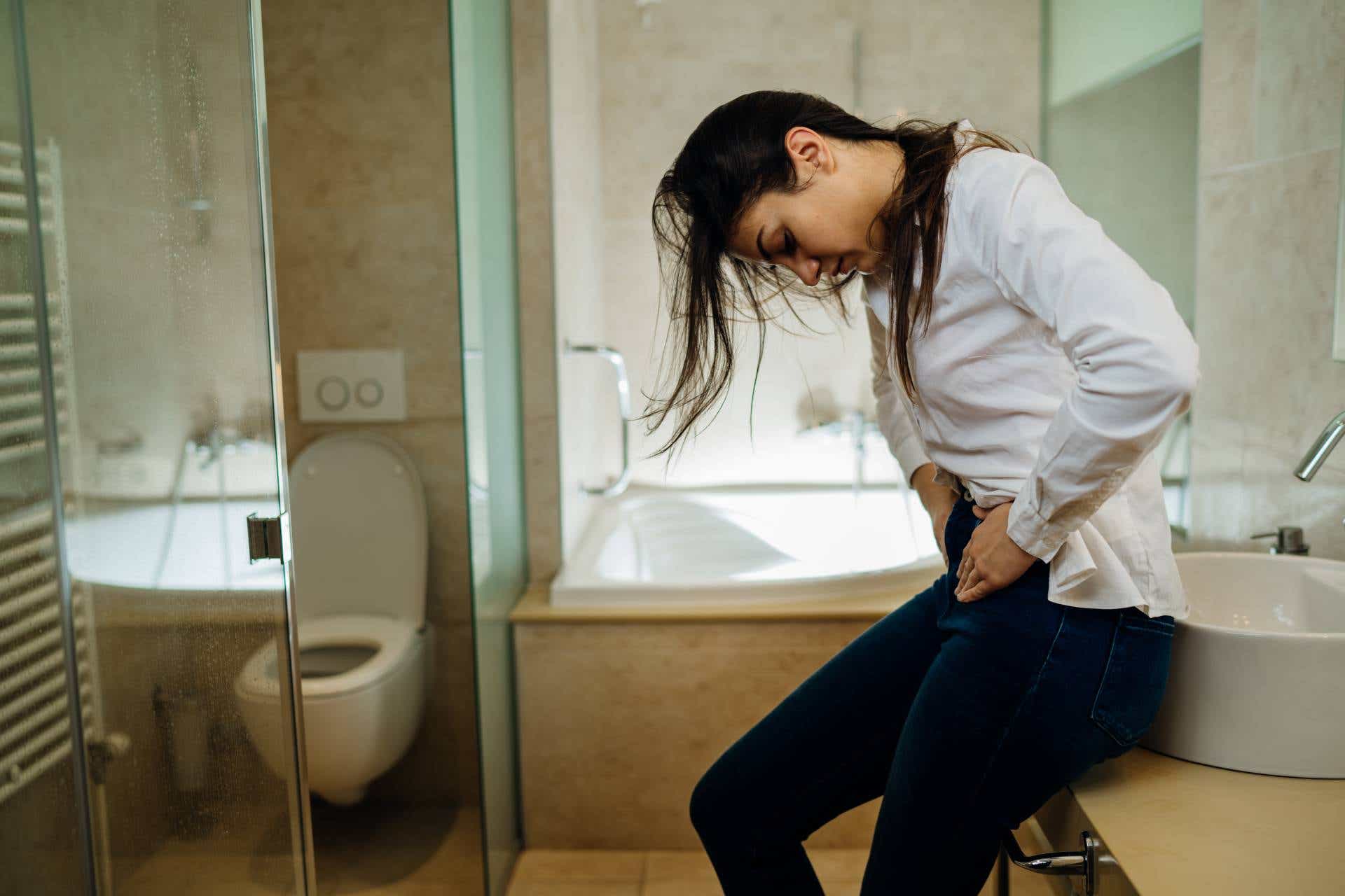 A woman suffering from stomach pain, a symptom of IBD