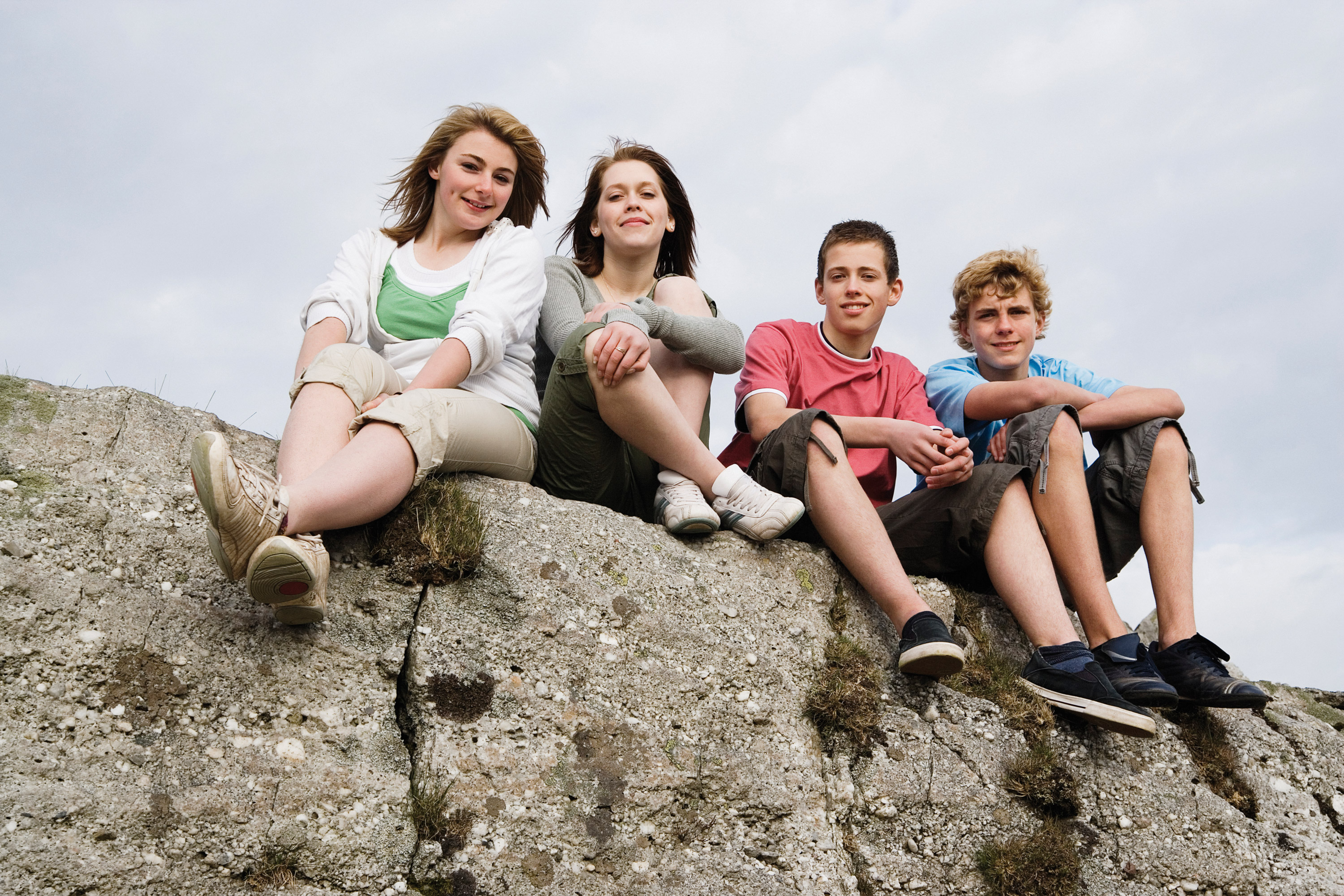 Teenagers sitting on a rock