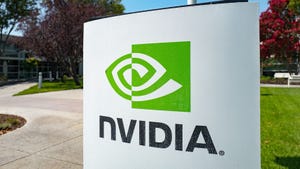 Nvidia's green and black logo on a white sign outside, surrounded by concrete paths, grass and trees
