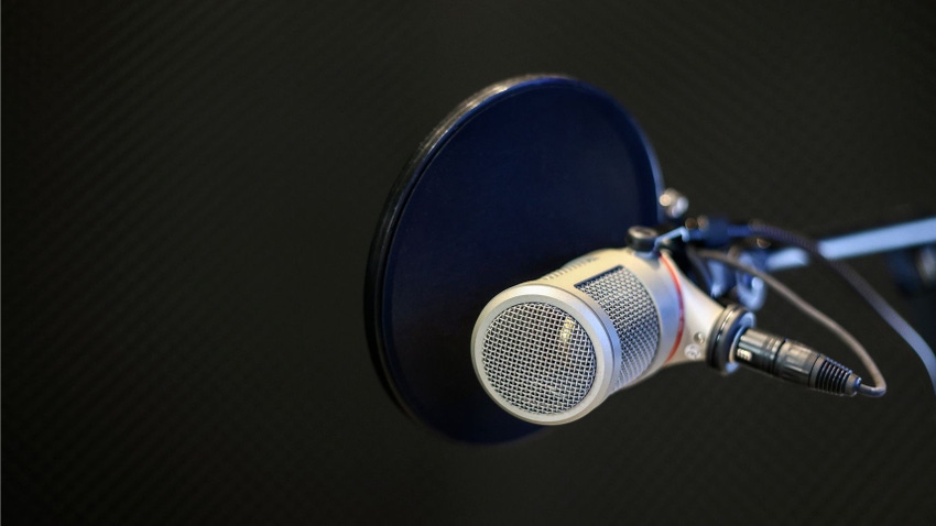 A microphone and pop filter in a recording studio
