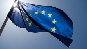 EU flag on a blue sky background. The EU AI Act stalls as lawmakers argue with member states on rules for generative AI and biometric systems