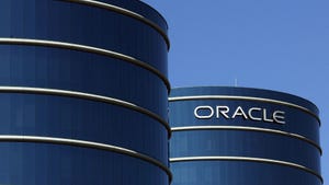 Two round blue-colored glass buildings. On the right, the Oracle logo is displayed