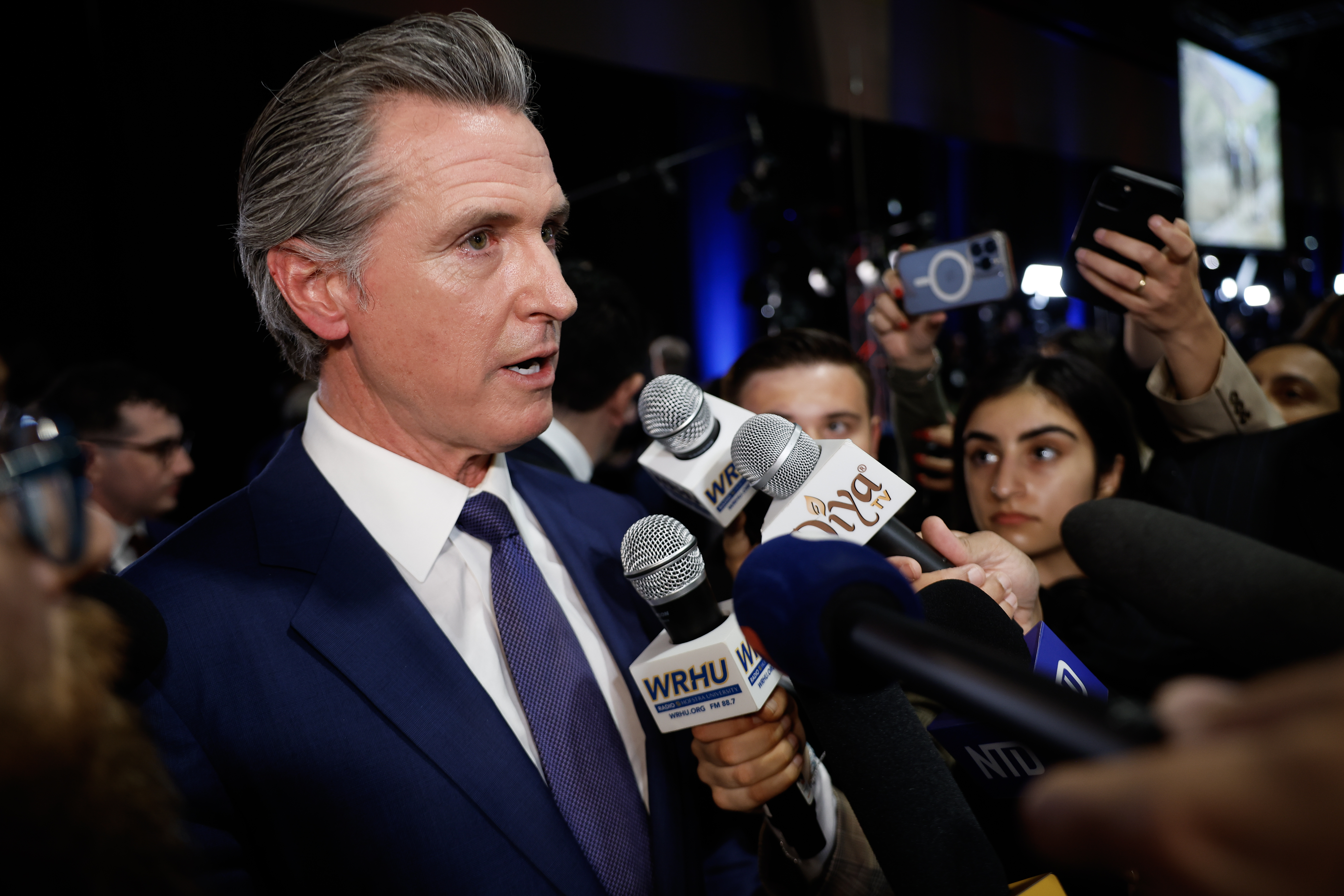 Governor of California Gavin Newsom speaks to reporters in the spin room following the presidential debate.