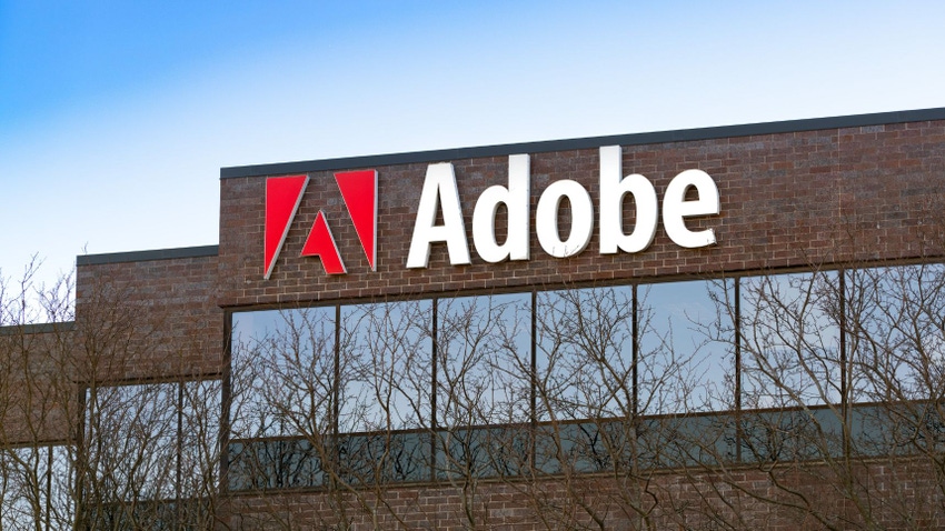 A red brick building with the Adobe logo affixed to the side