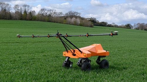 Robot spraying crops in field