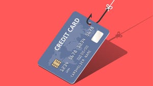 A grey credit card caught on a fishing line against a salmon-colored background