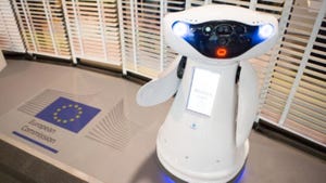A robot next to the European Commission logo. The European Commission just introduced the EU AI Act, which will regulate all AI systems across the EU
