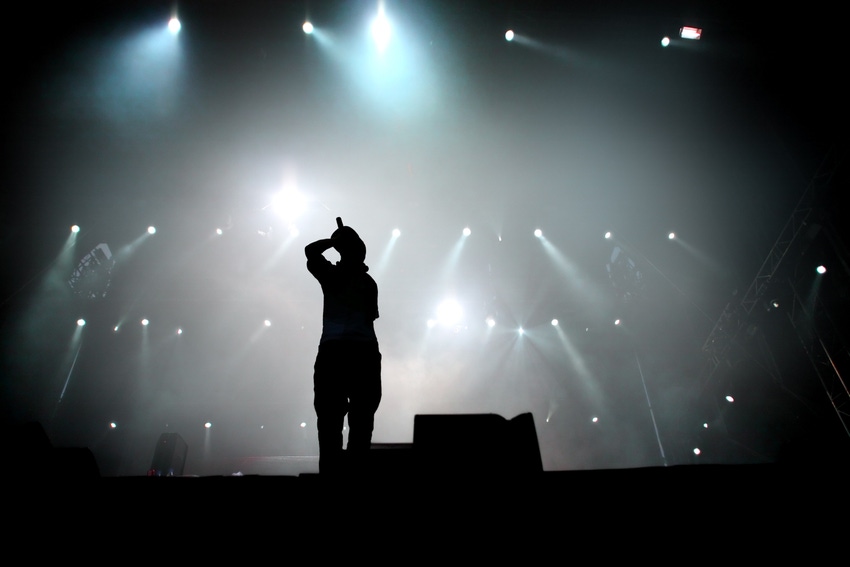 Silhouette of hip hop singer on stage