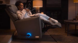 A woman sat on the La-Z-Boy Decliner chair. The Decliner uses AI to generate automatic responses via text so users can cancel plans guilt-free