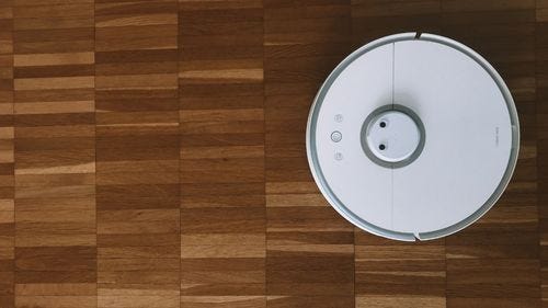 Robotic hoover on wood floor Robotic hoover on wood floor
