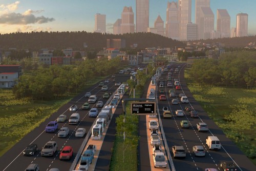 An image of traffic on wide roads leading to a city in the background