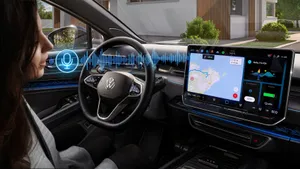 A person inside a VW vehicle interacting with the built-in voice assistant