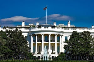 Photo of the White House with a blue sky 