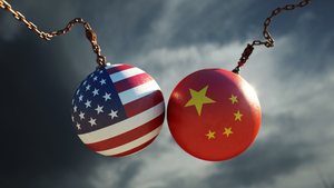 Two wrecking balls colliding, one with a U.S. flag, one with China's flag