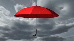 Red umbrella hovering in the air with raindrops falling around it