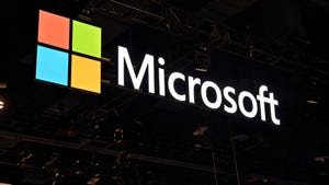 The word Microsoft held aloft in a white font next to the Microsoft logo on a black background