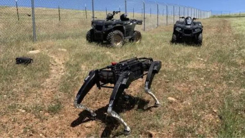 Robot dogs from Ghost Robotics patrolling sandy environments along the US/Mexico border. The robots are 'mechanical reinforcements' for border guards.
