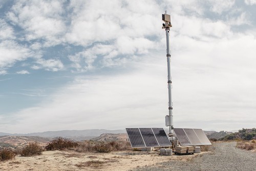 Image of a communications pole in an empty landscape, with solar panels Image of a communications pole in an empty landscape, with solar panels