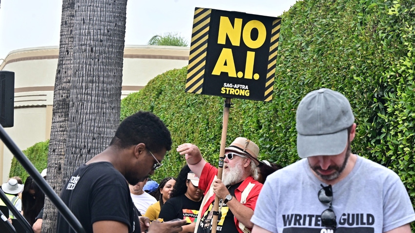 Man holding a sign in a picket line that says 'No AI'