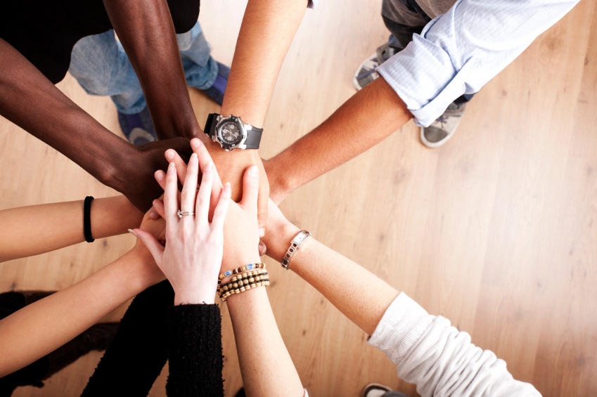 Picture of 5 sets of hands in a circle, in different skin tones overlaying each other