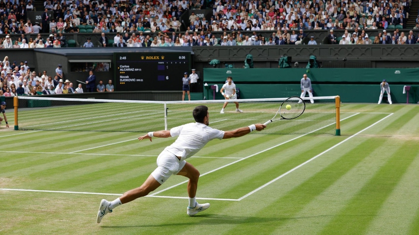 Novak Djokovic returns serve in his defeat to Carlos Alcaraz in Wimbledon 2023