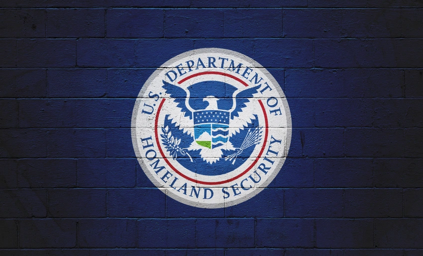 The Homeland Security Department seal on a blue brick wall