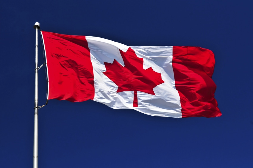 Canadian flag against blue sky