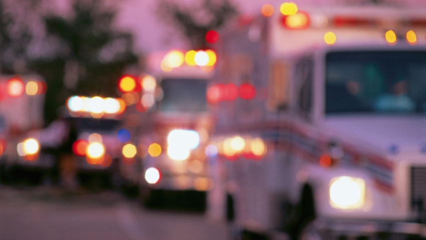 Out of focus ambulances driving on a road