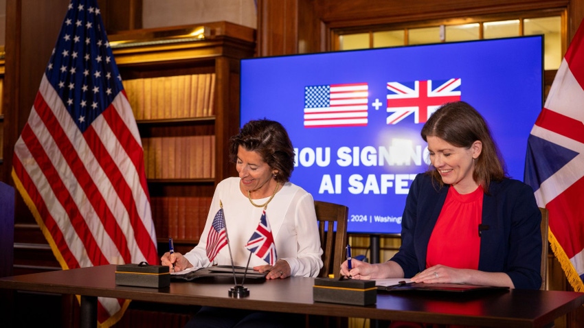 Michelle Donelan and Secretary of Commerce Gina Raimondo sign an agreement which will see them work together to develop tests for AI models