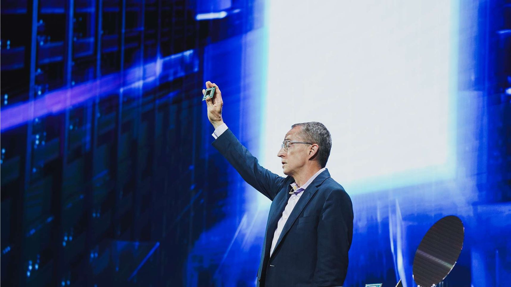 A man in a suit holds up a semiconductor