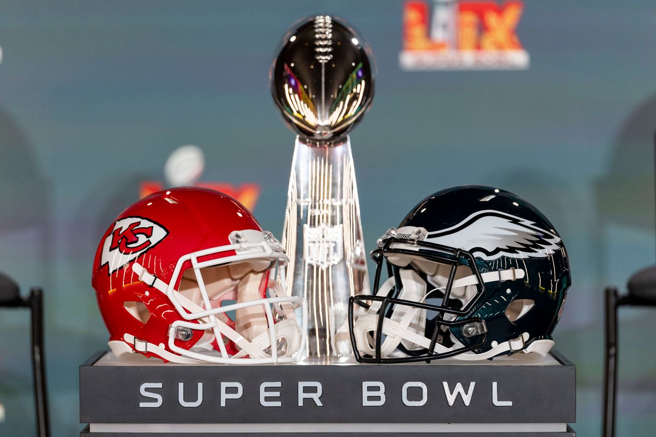 The Super Bowl trophy between helmets from the Kansas City Chiefs and the Philadelphia Eagles. The Super Bowl trophy between helmets from the Kansas City Chiefs and the Philadelphia Eagles.