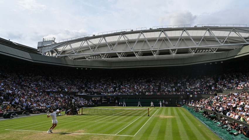 Carlos Alcaraz serves against Novak Djokovic during their men's singles final tennis match on the last day of the 2023 Wimbledon Championships