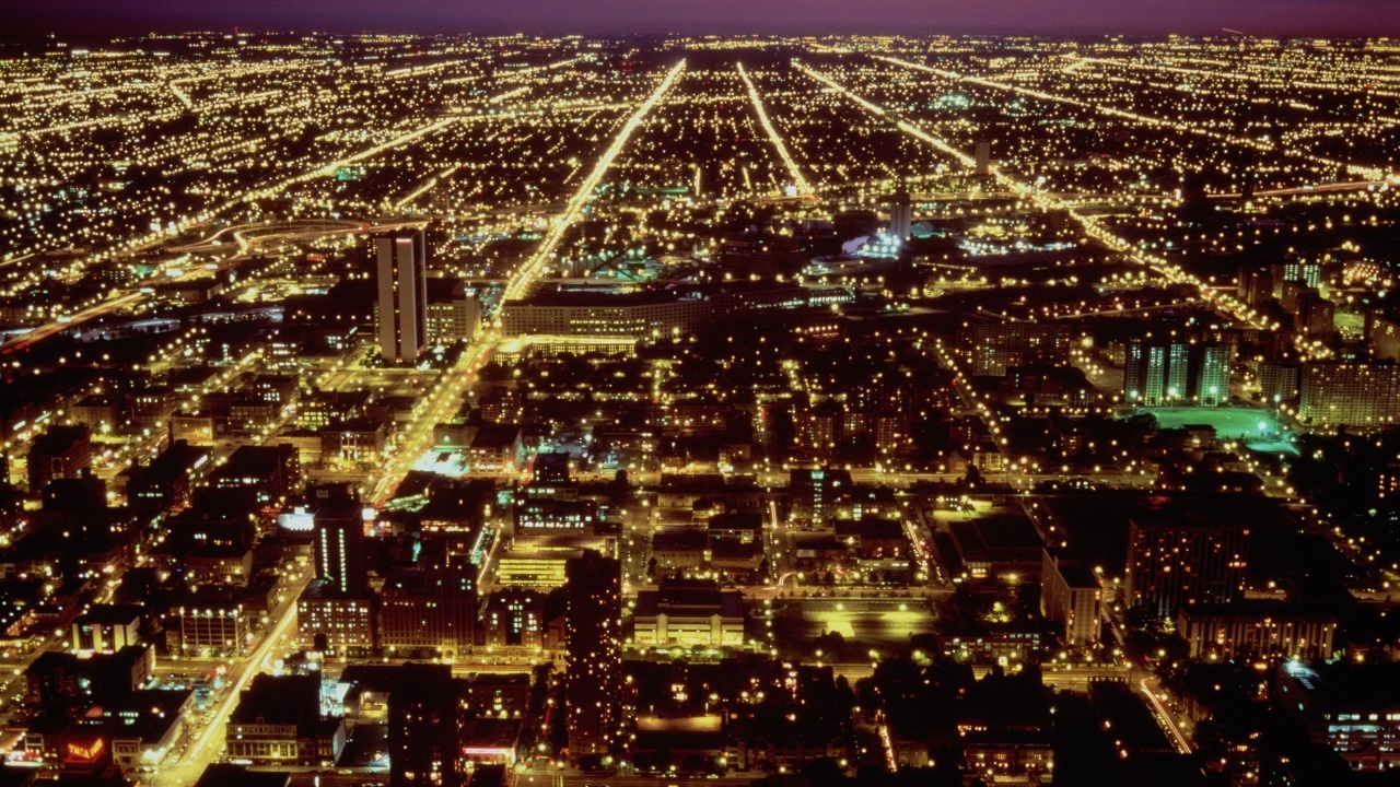 A lit up city grid system from above A lit up city grid system from above