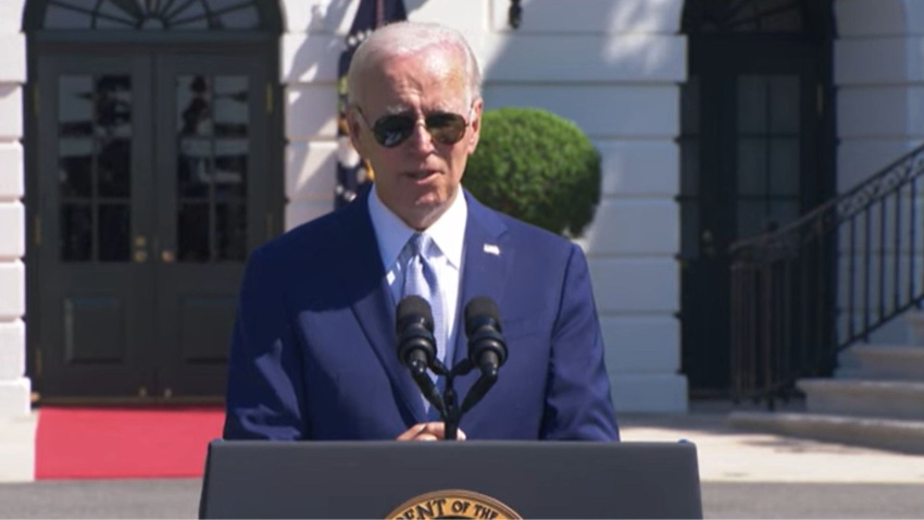 President Joe Biden talking at a podium on the White House lawn