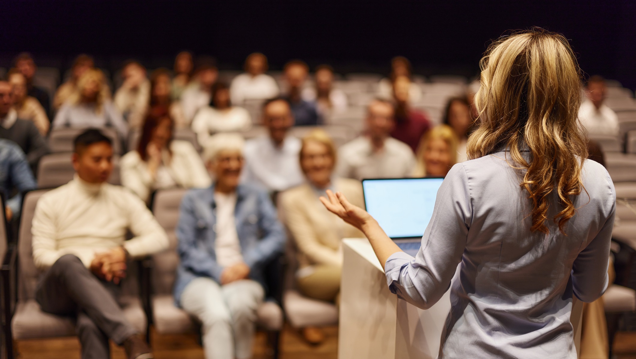 Conference audience listening to a presentation at a healthcare education event.