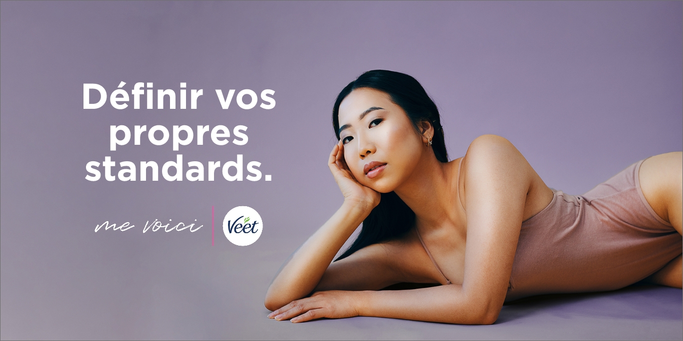 Une fille en maillot de bain étendue avec la main sous le menton et les textes « Définissez vos propres normes » et « Me voici » ainsi que le logo Veet.