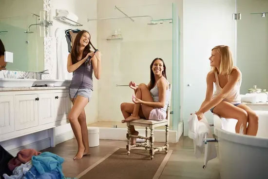 Three girls in the bathroom hanging out while doong self-care and hair removal 