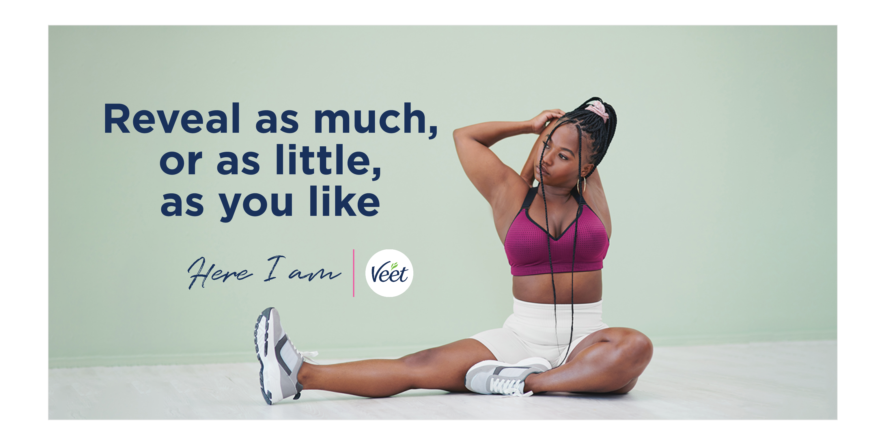Girl sitting and stretching her hand showing underarm with copy "Reveal as much or as little as you like" with Here I am and Veet logo