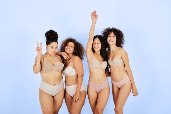 A group of women in their underwear posing happily