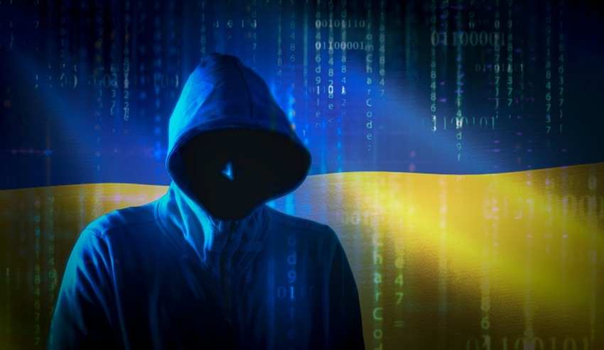 Cyber war concept with hoodie-wearing hacker in shadow against Ukrainian flag